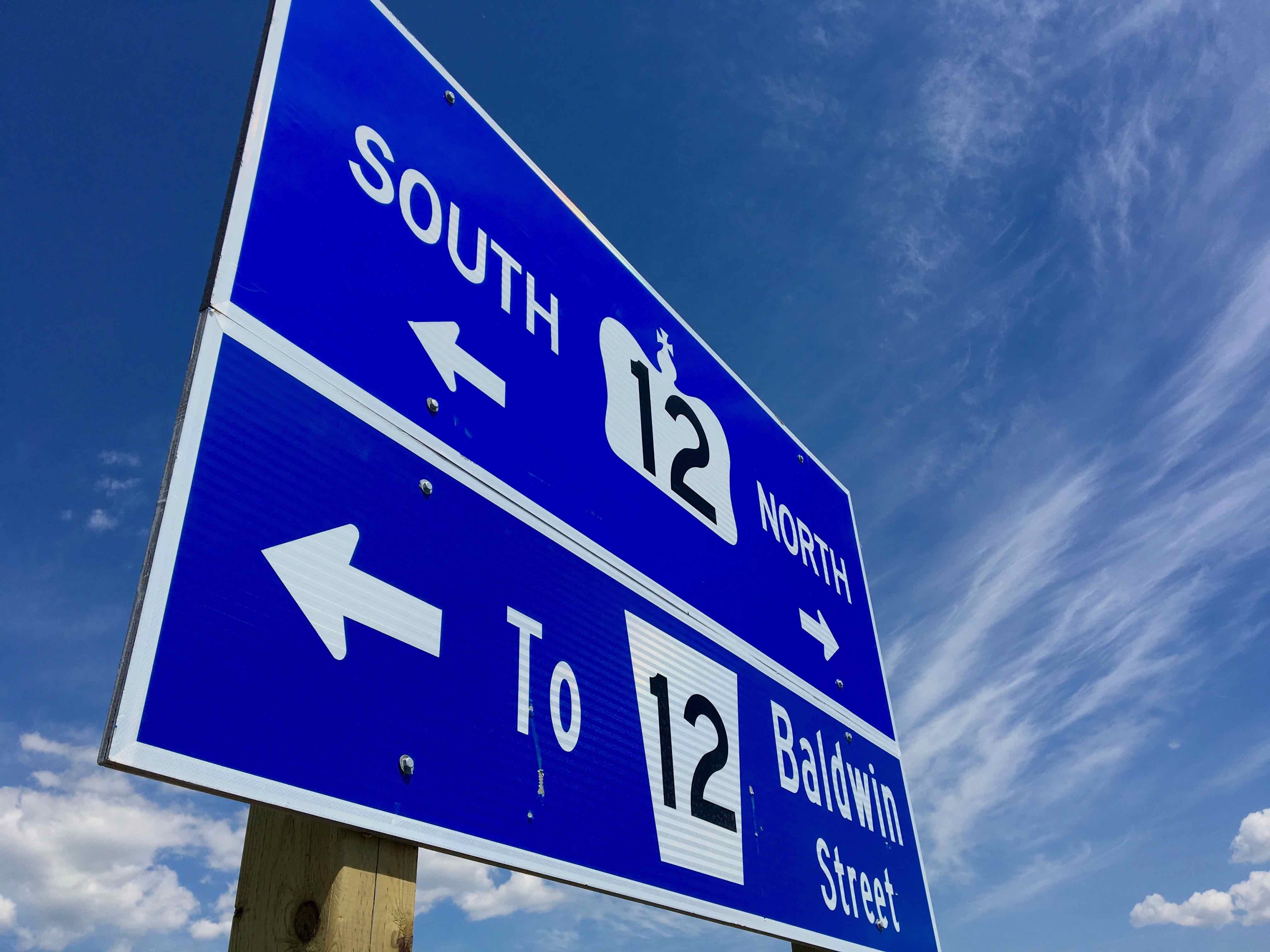 Sign on exit to Baldwin St from 407 showing Highway 12 to the south and north.