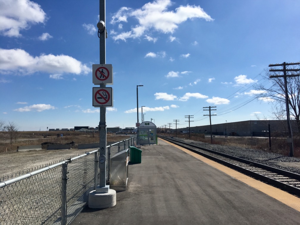 Looking down the Downsview Park platform, the CN Tower peeks over the hills in the distance.