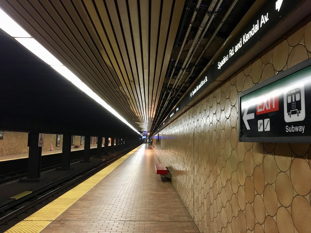 Looking down Line 1 SPADINA platofrm from the north end. Sign just visible to right.